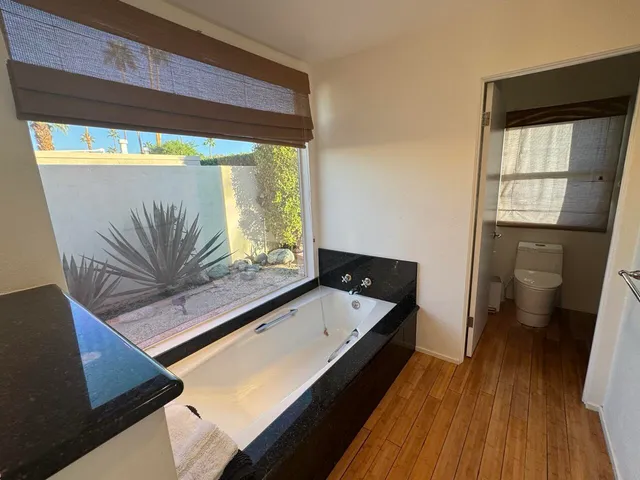 a living room with a bed furniture and a large window