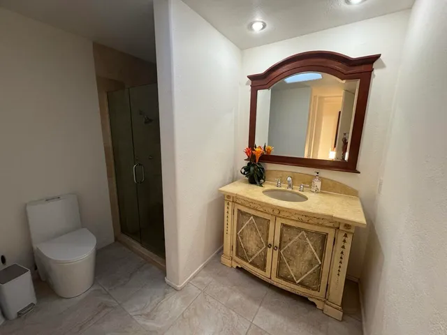 a bathroom with a toilet sink and mirror