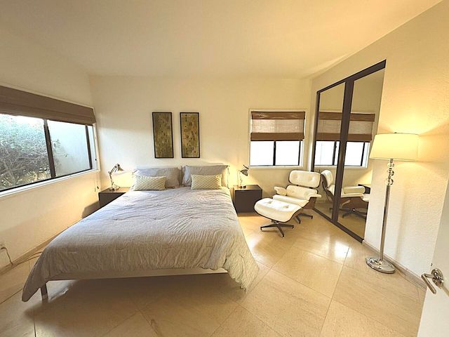 a bedroom with a bed and glass window