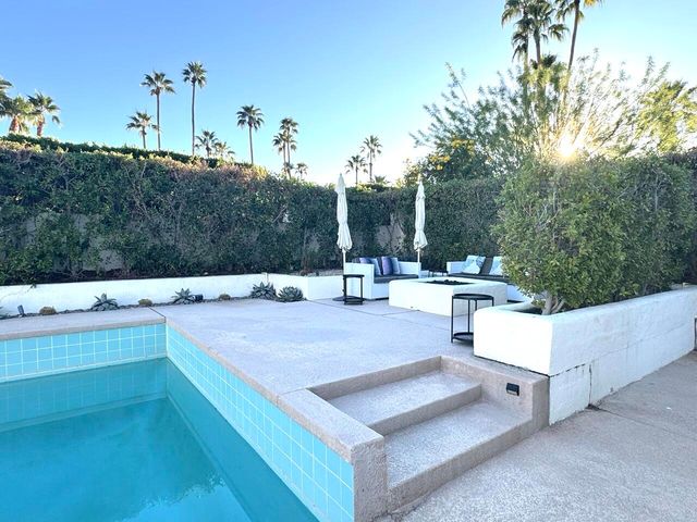 a view of a terrace with a bench and trees