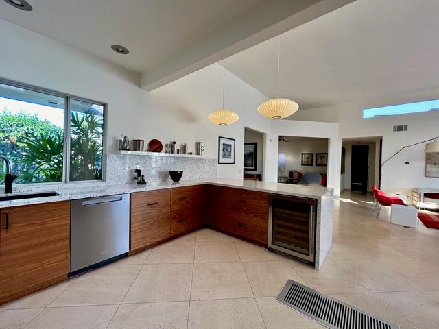 a large kitchen with stainless steel appliances granite countertop a sink and cabinets