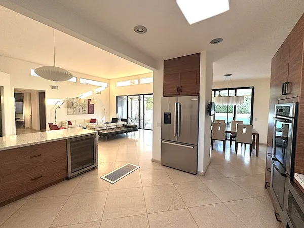 a kitchen with stainless steel appliances granite countertop a refrigerator and a sink
