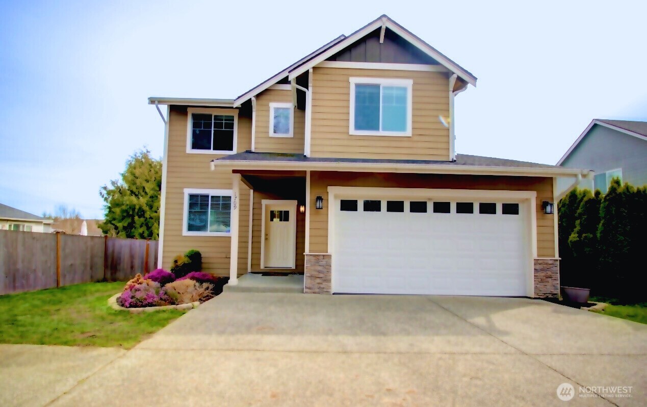 1709 Hillcrest Loop Mount Vernon, WA 98274 - Photo 1 of 40 a front view of a house with a yard and garage