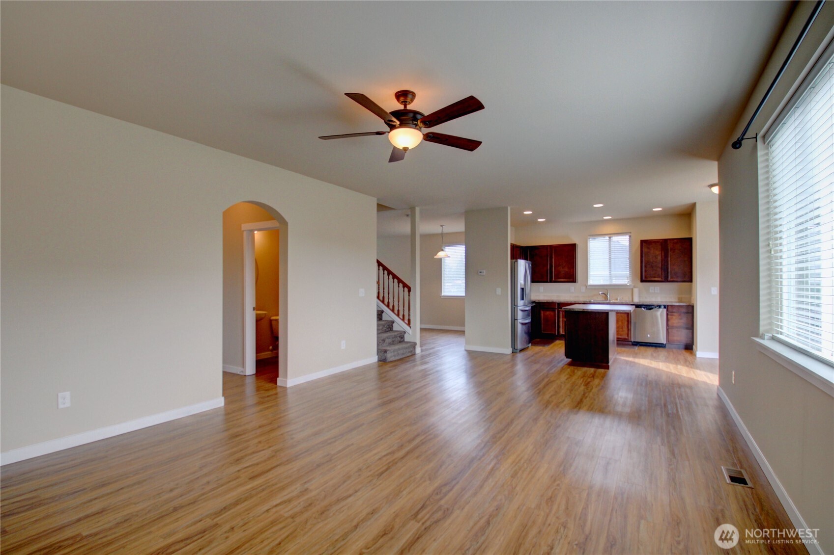 1709 Hillcrest Loop Mount Vernon, WA 98274 - Photo 12 of 40 a view of an empty room with wooden floor and a kitchen