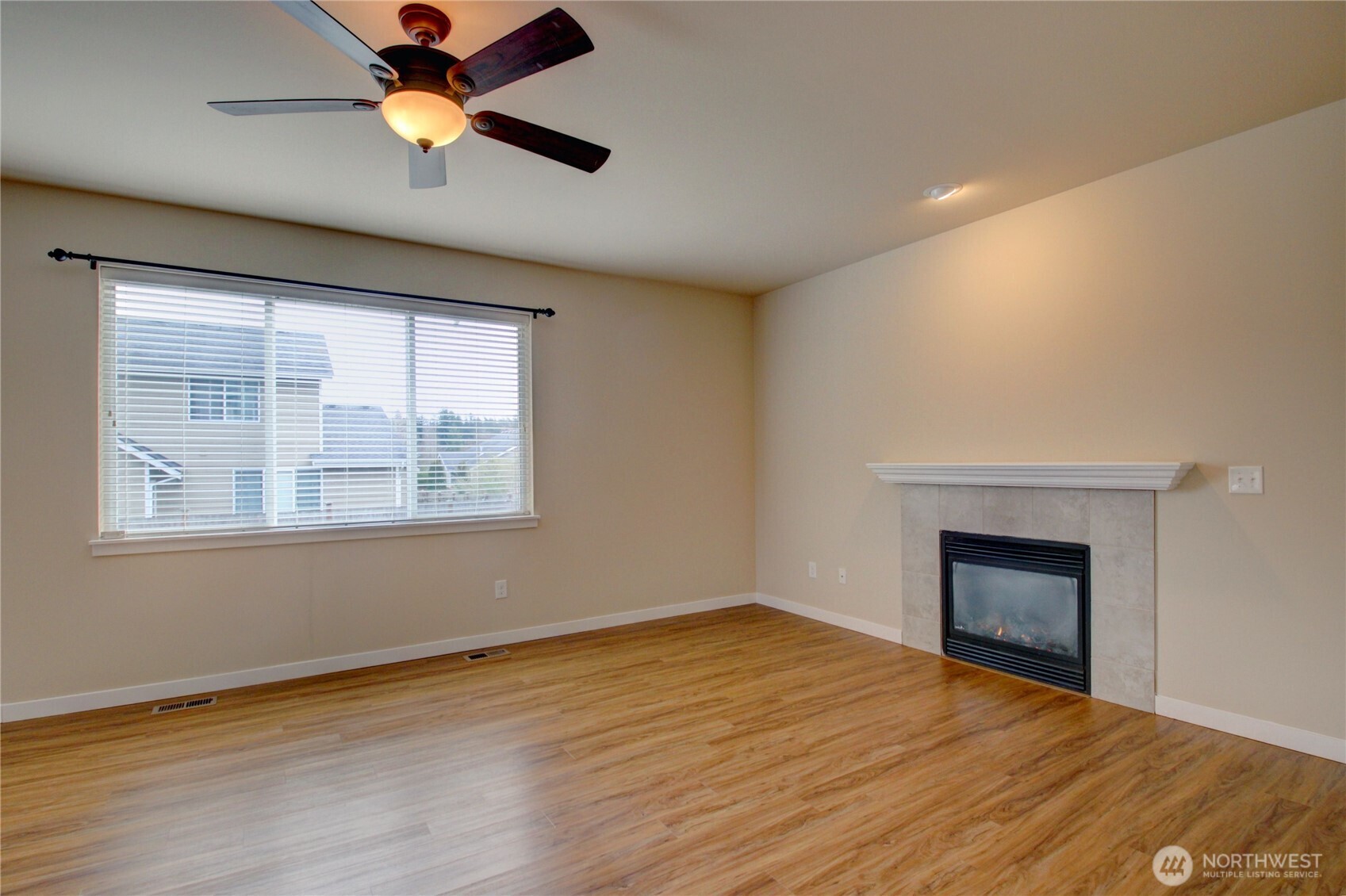 1709 Hillcrest Loop Mount Vernon, WA 98274 - Photo 15 of 40 an empty room with wooden floor ceiling fan and windows
