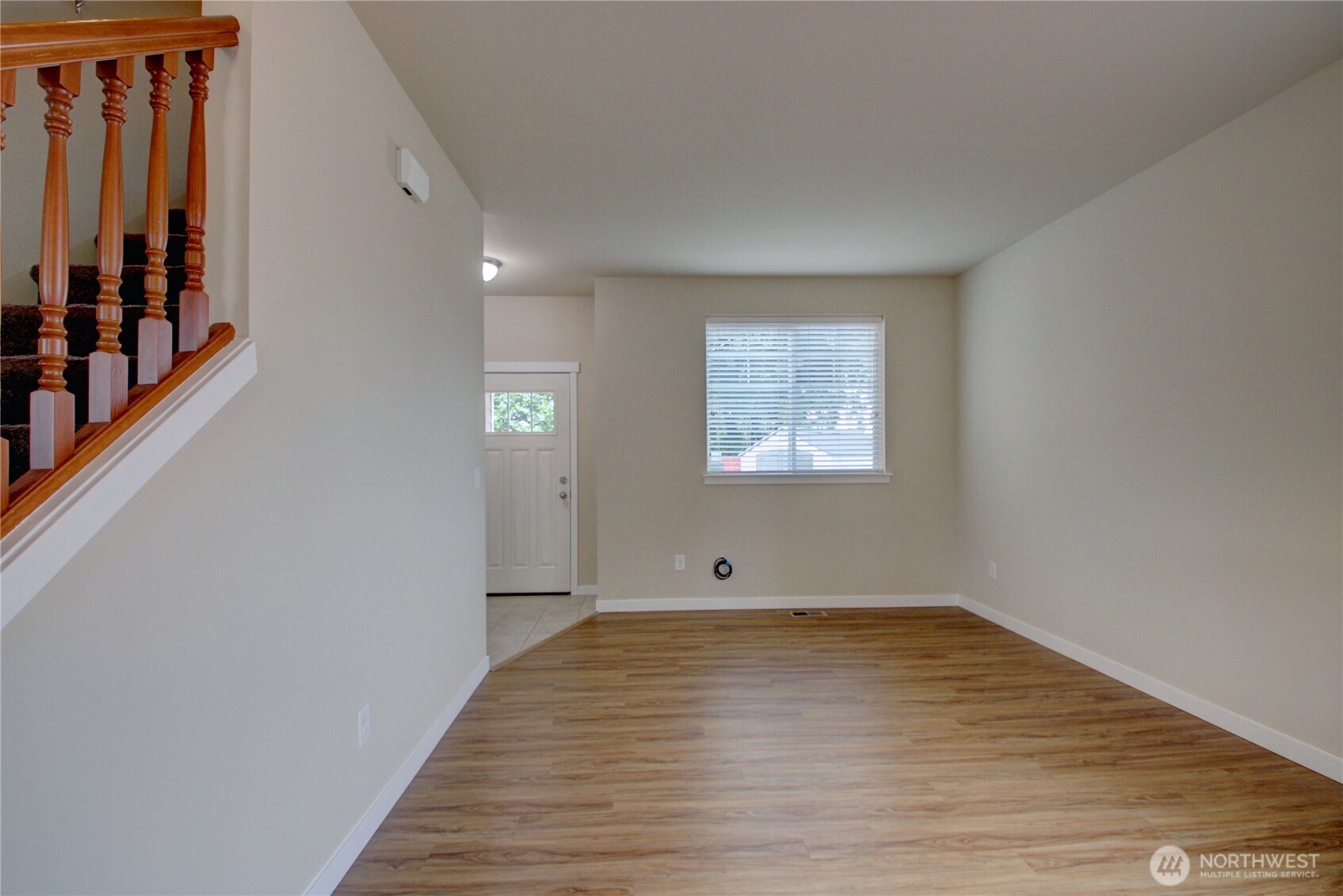1709 Hillcrest Loop Mount Vernon, WA 98274 - Photo 6 of 40 a view of an empty room with wooden floor and a window