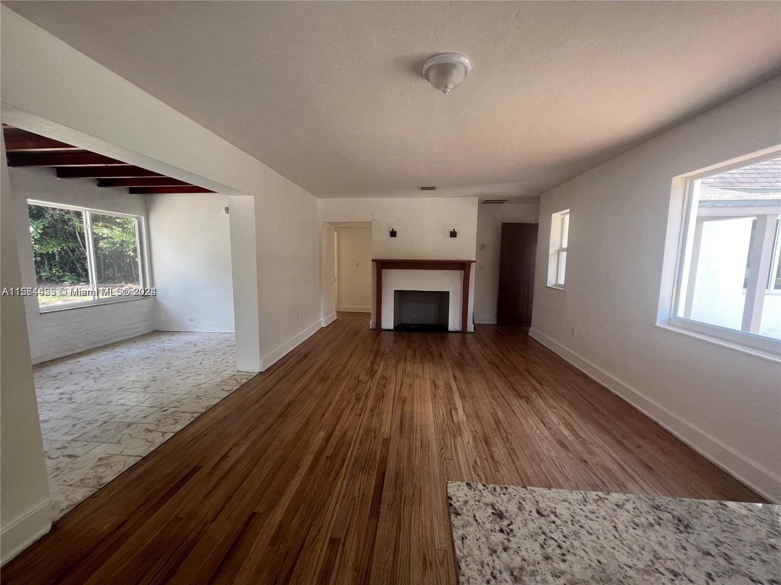 245 Southwest 24th Road, Unit 1 Miami, FL 33129 - Photo 11 of 14 a view of empty room with wooden floor and fan