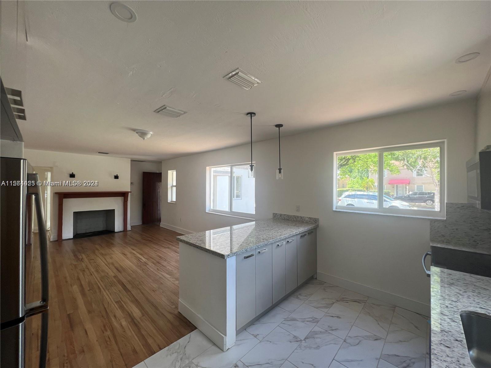 245 Southwest 24th Road, Unit 1 Miami, FL 33129 - Photo 12 of 14 a view of a kitchen with a sink dishwasher and fireplace