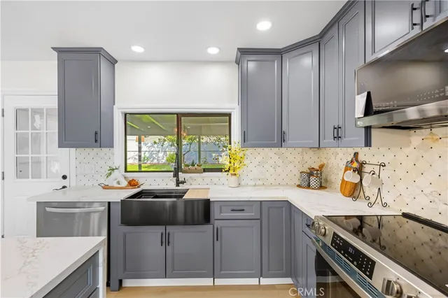 a kitchen with a sink stove top oven and cabinets