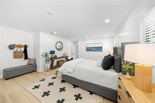 a bedroom with a bed and wooden floor