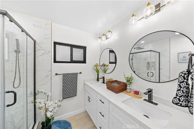 a bathroom with a sink a mirror and a shower