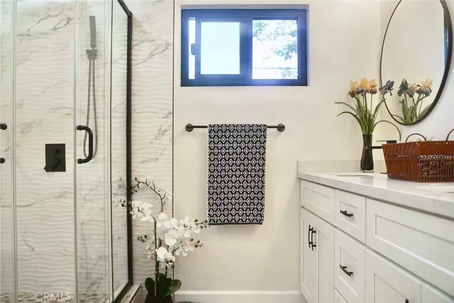 a bathroom with a shower sink and mirror