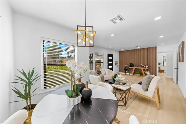 a living room with furniture potted plant and a chandelier