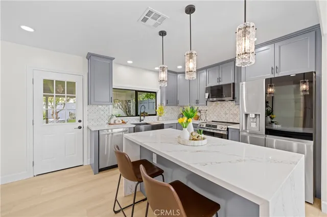 a kitchen with refrigerator cabinets and wooden floor