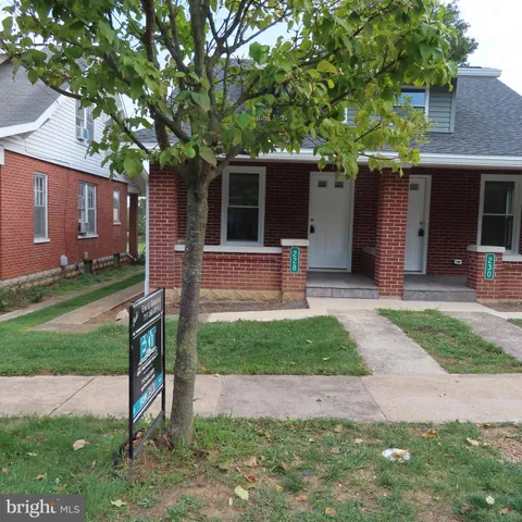 a front view of house with a garden and patio