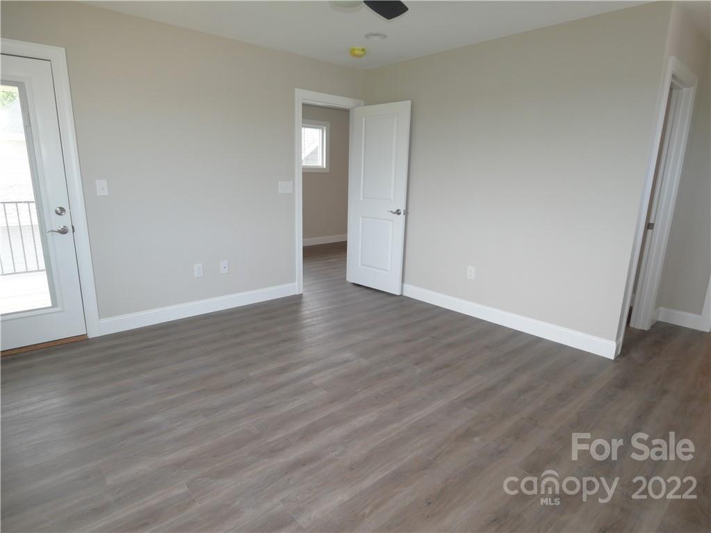 2636 2nd Street Northeast Hickory, NC 28601 - Photo 17 of 23 a view of an empty room with wooden floor and a window