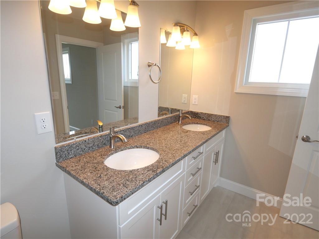 2636 2nd Street Northeast Hickory, NC 28601 - Photo 19 of 23 a bathroom with a granite countertop sink and a mirror