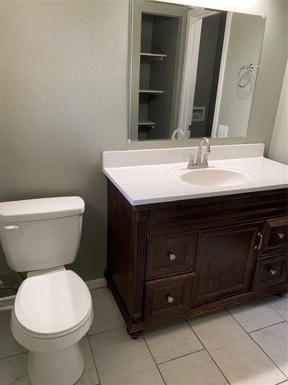 721 Barbara Street Athens, TX 75751 - Photo 13 of 18 a bathroom with a toilet sink and mirror