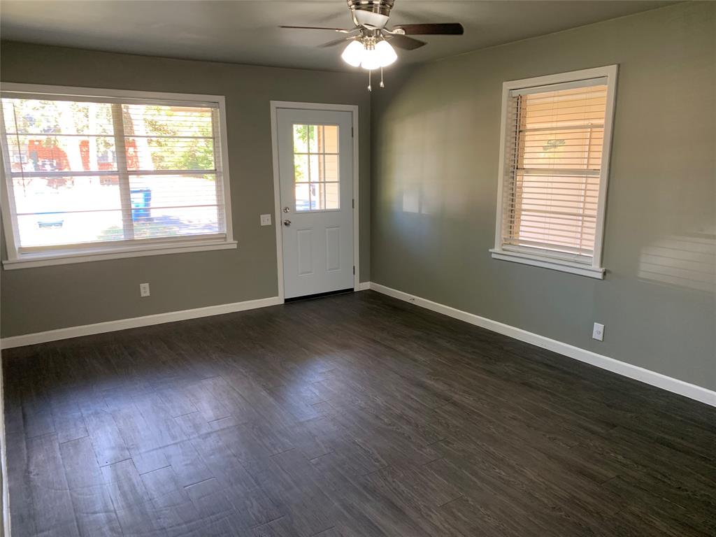 721 Barbara Street Athens, TX 75751 - Photo 3 of 18 a view of an empty room with wooden floor and a window