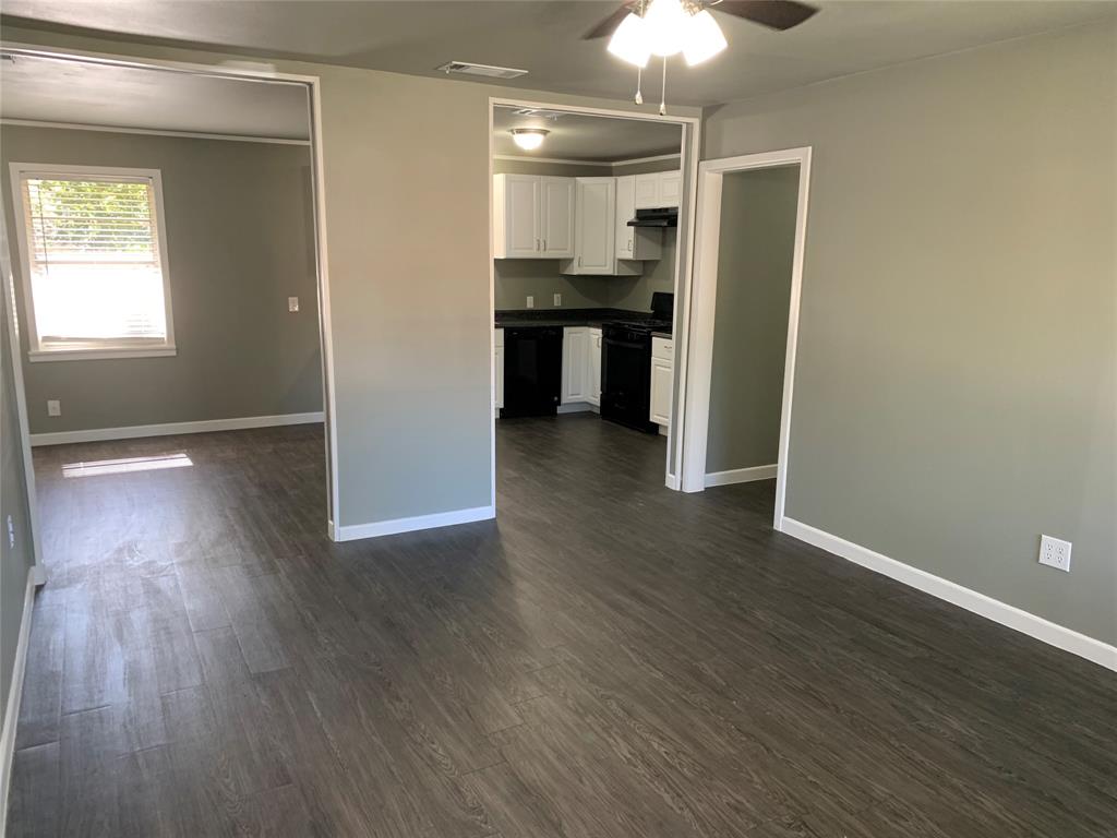 721 Barbara Street Athens, TX 75751 - Photo 4 of 18 an empty room with wooden floor closet and windows