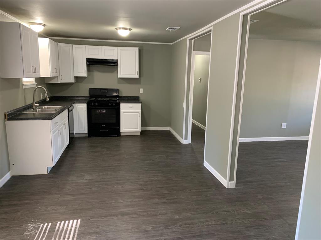 721 Barbara Street Athens, TX 75751 - Photo 5 of 18 a kitchen with stainless steel appliances granite countertop a stove a sink and a refrigerator