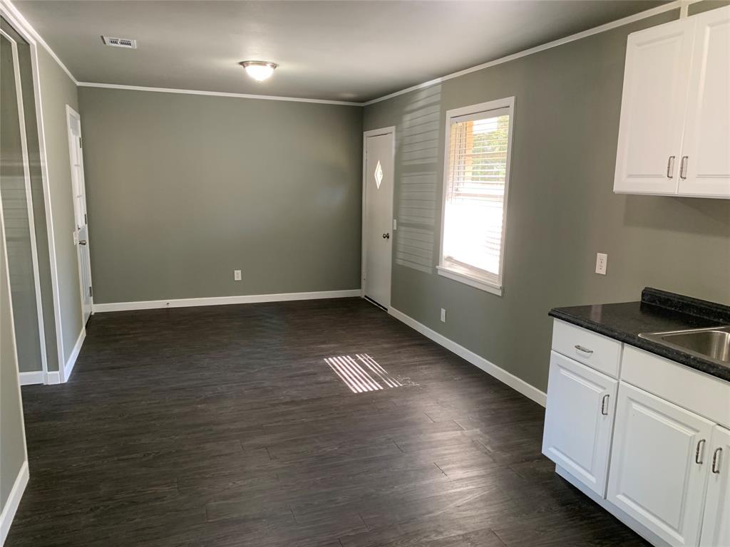 721 Barbara Street Athens, TX 75751 - Photo 7 of 18 a view of a kitchen with wooden floor and window
