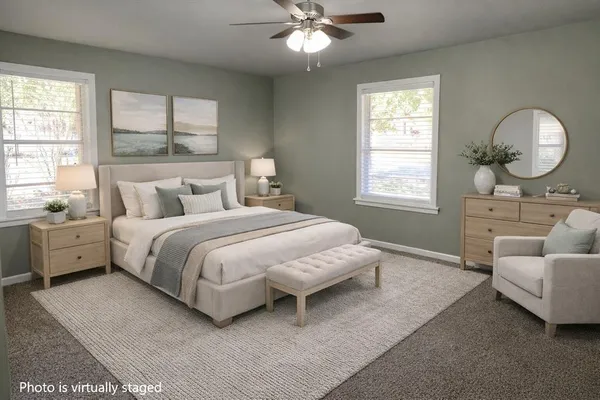 a spacious bedroom with a bed and a chandelier