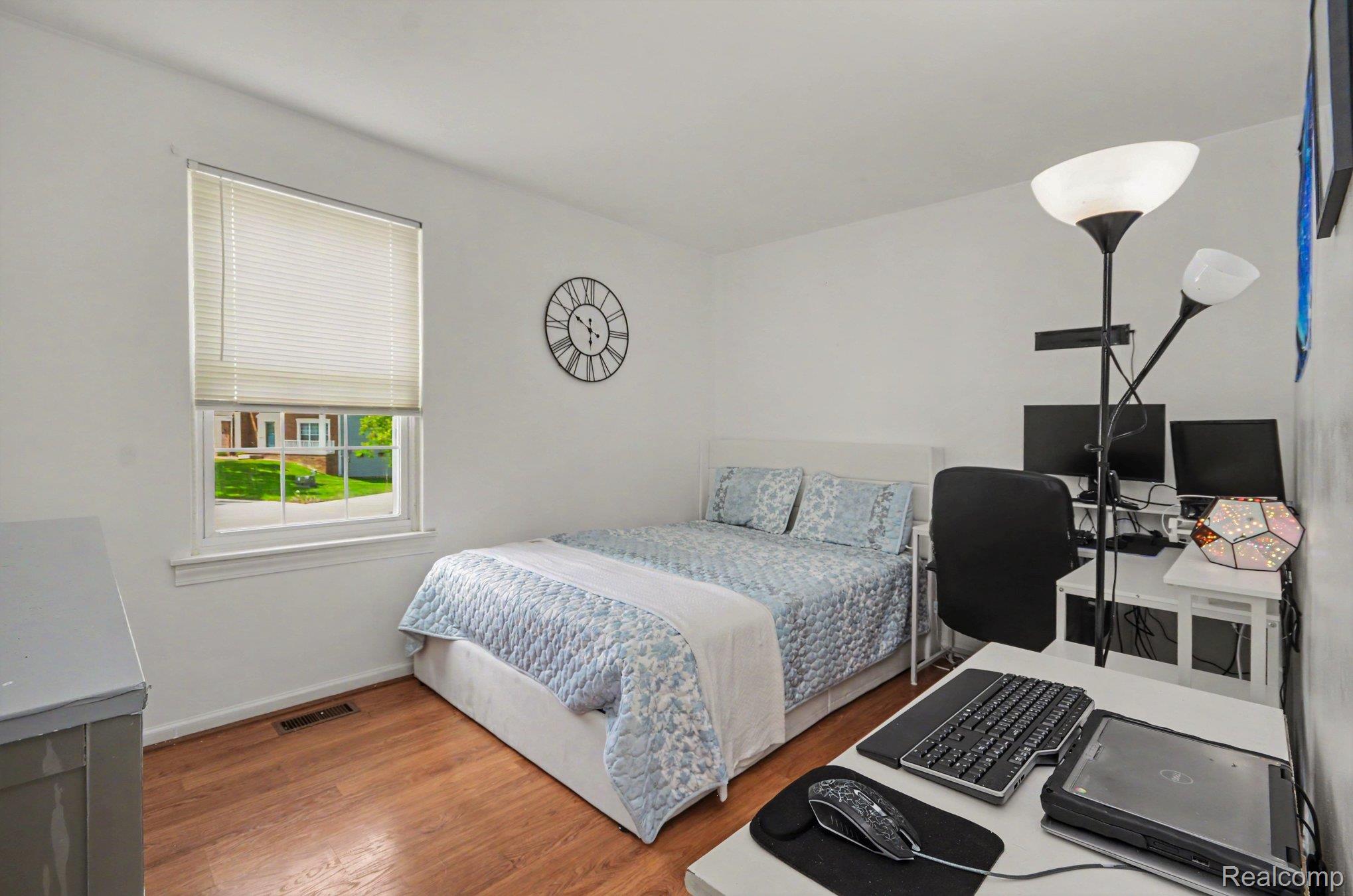 425 Thornridge Court Rochester, MI 48307 - Photo 20 of 35 Bright bedroom featuring wood-finish flooring and a single window with blinds