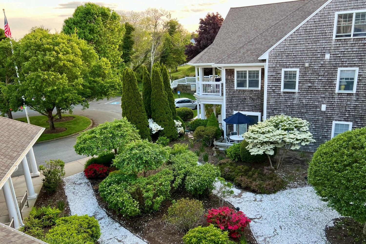 912 Main Street, Unit 308 Chatham, MA 02633 - Photo 15 of 65 a view of a house with a flower garden