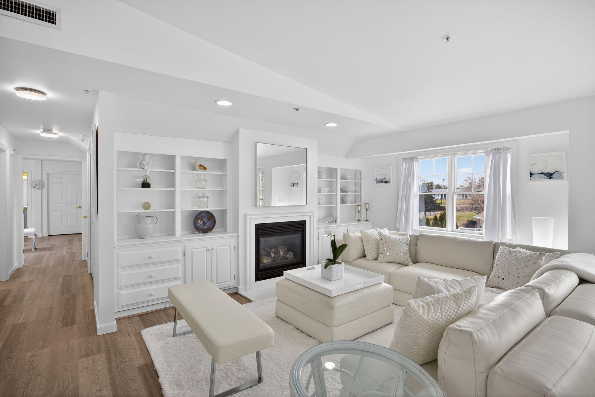 912 Main Street, Unit 308 Chatham, MA 02633 - Photo 29 of 65 a living room with furniture a fireplace and a flat screen tv