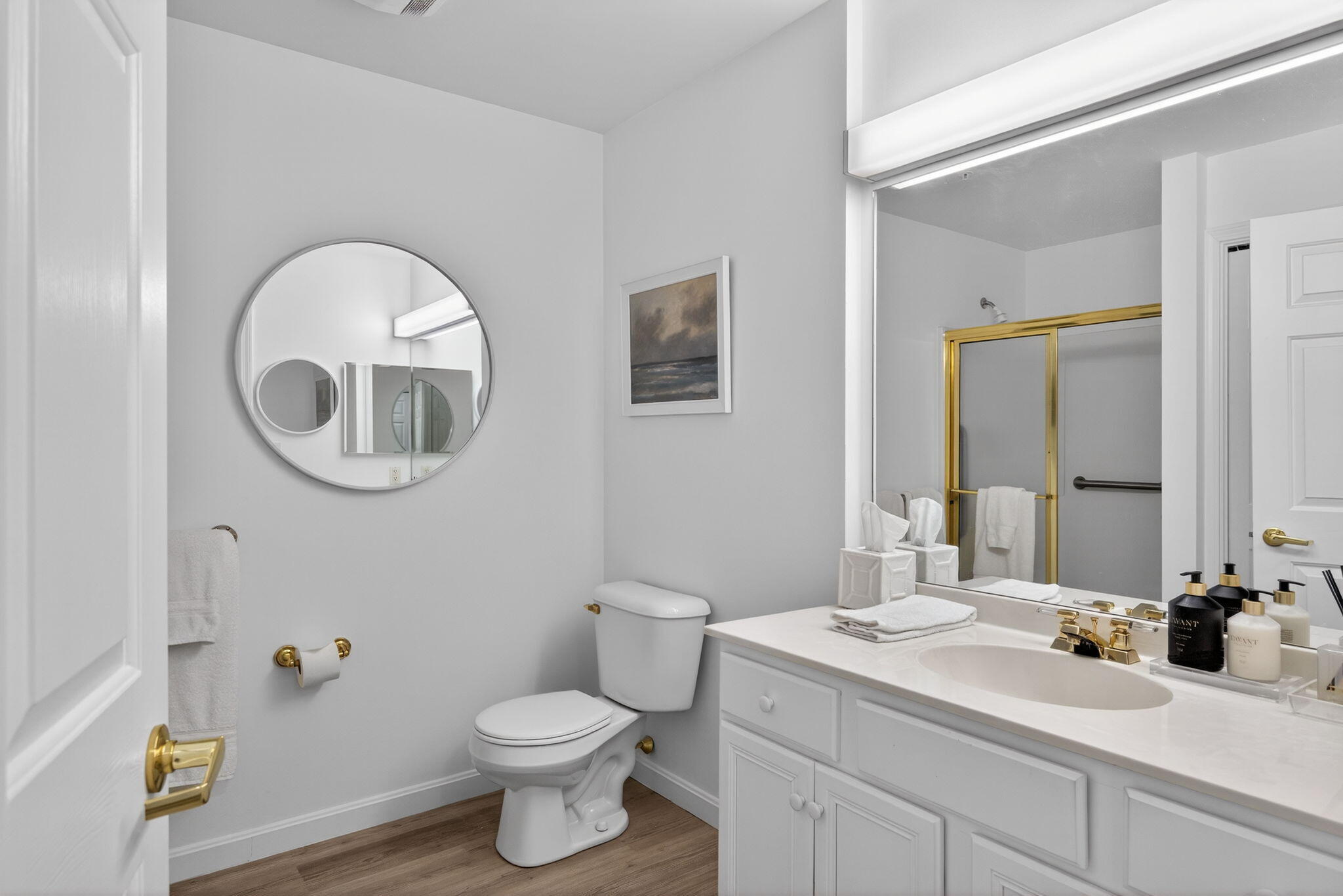 912 Main Street, Unit 308 Chatham, MA 02633 - Photo 31 of 65 a bathroom with a toilet a sink a mirror and vanity