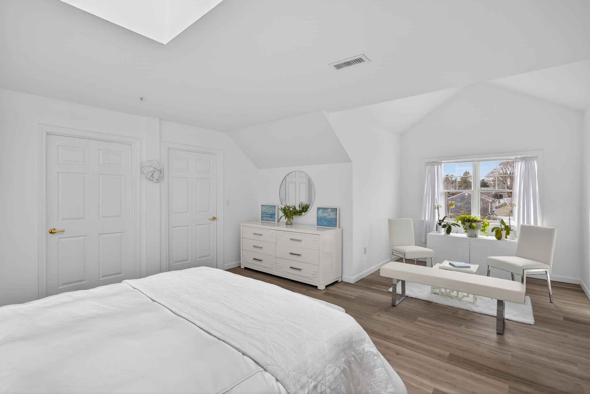 912 Main Street, Unit 308 Chatham, MA 02633 - Photo 37 of 65 a bedroom with a bed and a chair