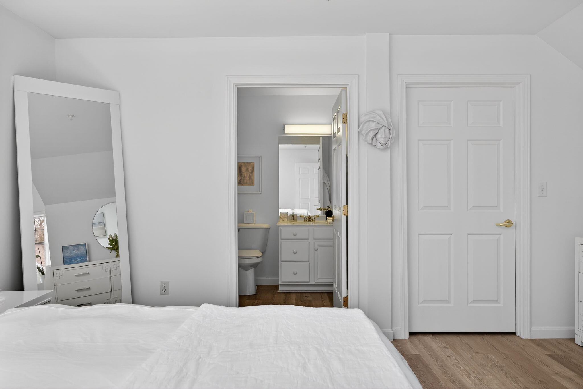 912 Main Street, Unit 308 Chatham, MA 02633 - Photo 44 of 65 a bedroom with a bed and a mirror