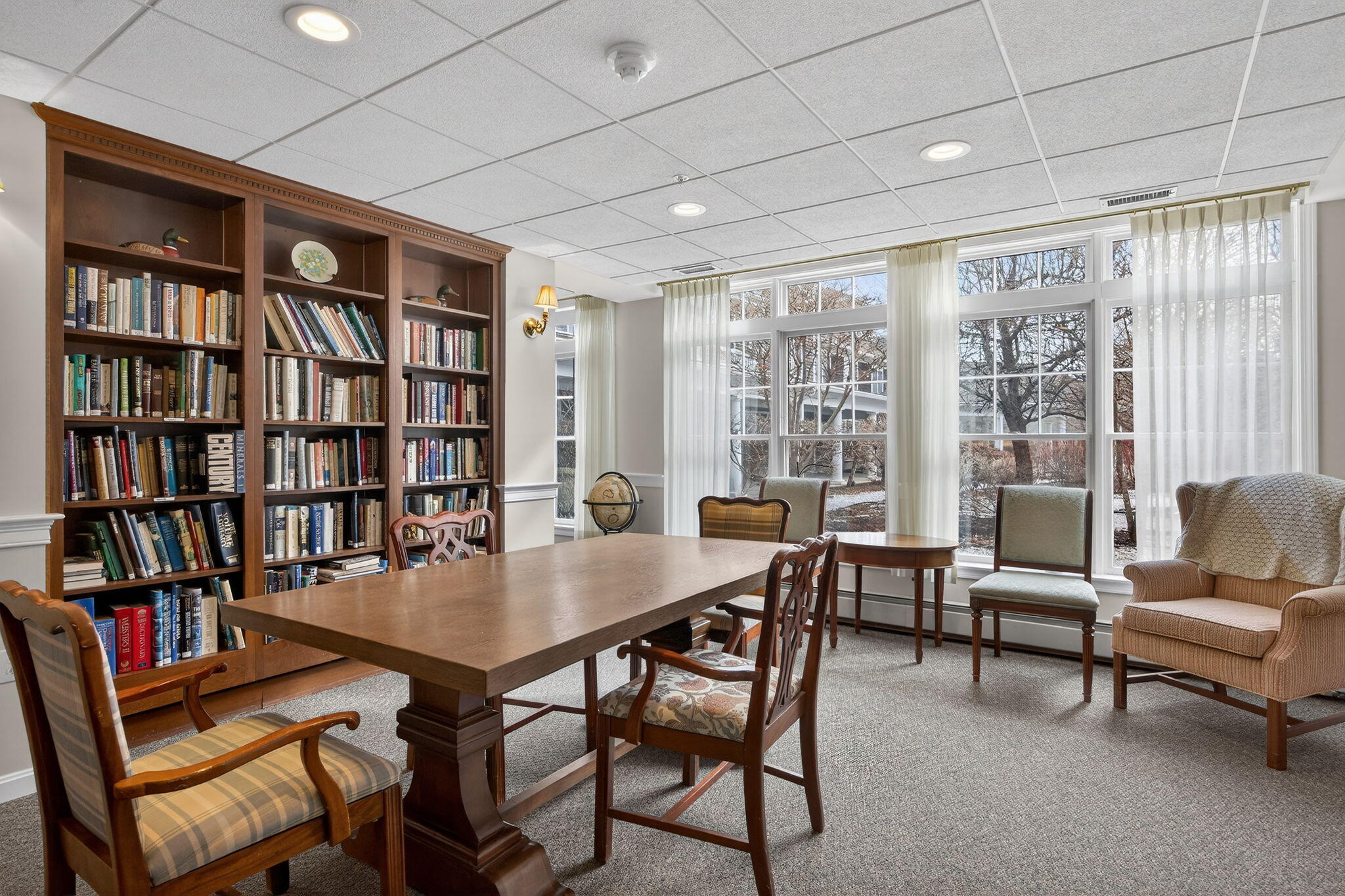 912 Main Street, Unit 308 Chatham, MA 02633 - Photo 54 of 65 a view of a livingroom with furniture and a bookshelf
