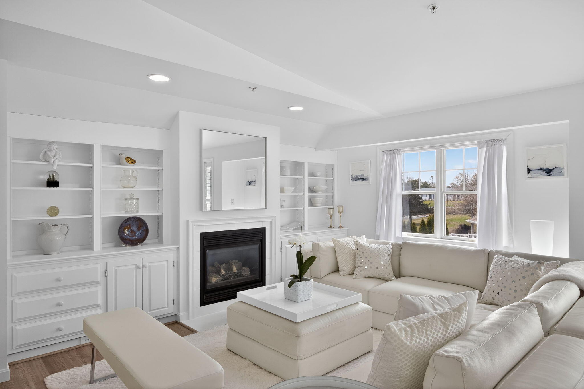 912 Main Street, Unit 308 Chatham, MA 02633 - Photo 7 of 65 a living room with furniture a fireplace and a large window