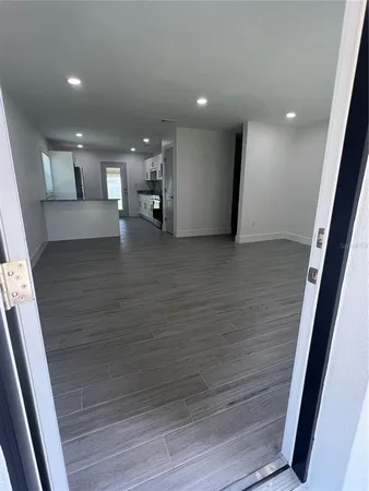 a view of empty room with wooden floor