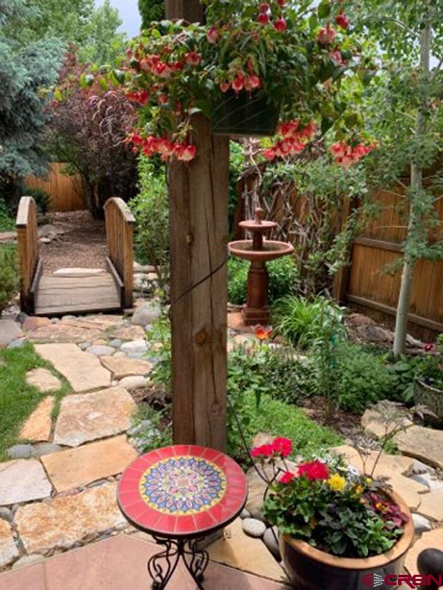 343 Jenkins Ranch Road Durango, CO 81301 - Photo 34 of 35 a view of a backyard with plants and a fountain