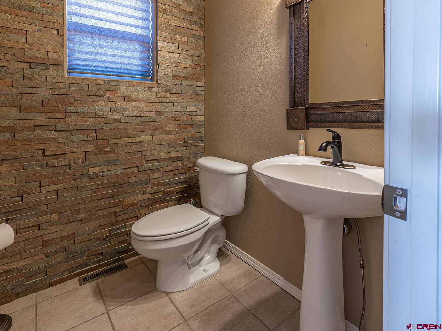 343 Jenkins Ranch Road Durango, CO 81301 - Photo 9 of 35 a bathroom with a sink a toilet and mirror