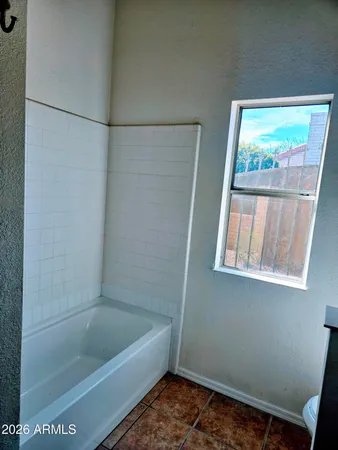 a bathroom with a bathtub and window