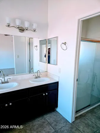 a bathroom with a sink a mirror and a shower