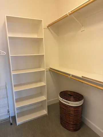 a bedroom with a bed and painting on the wall