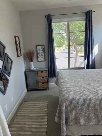 a bathroom with a granite countertop toilet a sink and a mirror