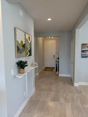 a view of a hallway with a flower pot