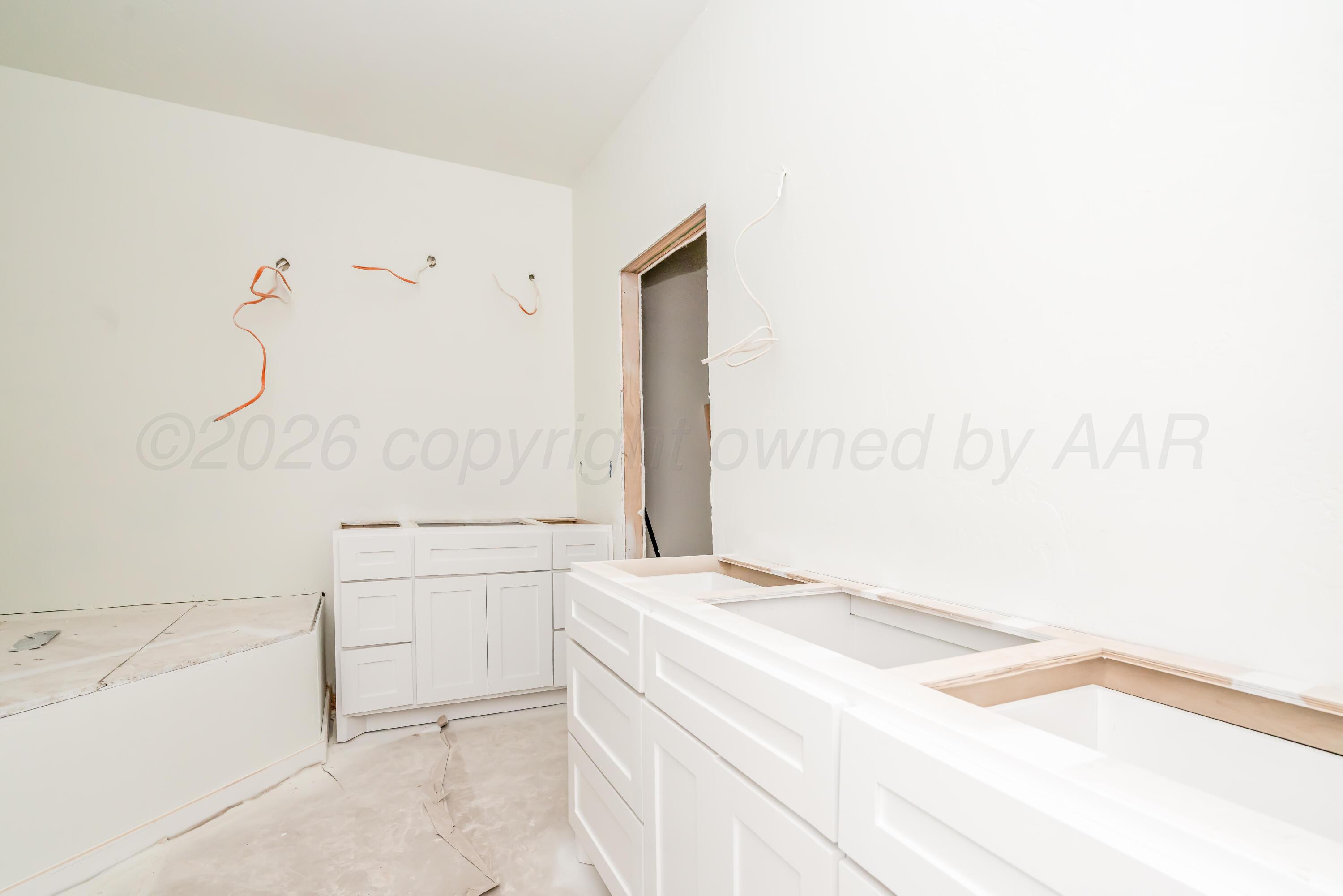 19900 Indian Spring Trail Amarillo, TX 79124 - Photo 12 of 33 a bathroom with a granite countertop sink a mirror and a bathtub