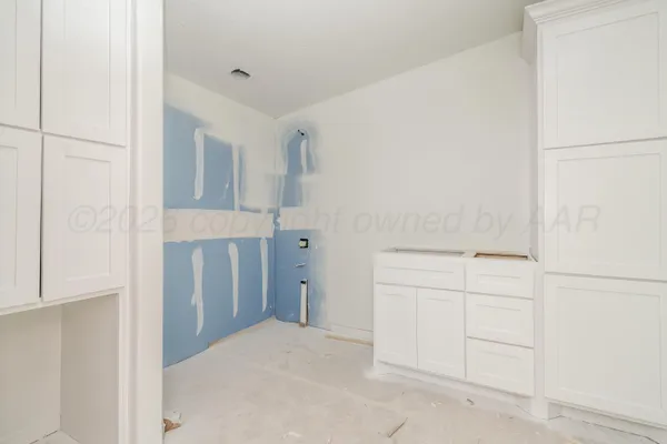 a view of a kitchen with a sink and cabinets