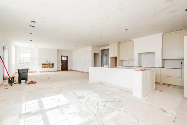 a view of kitchen with furniture and refrigerator