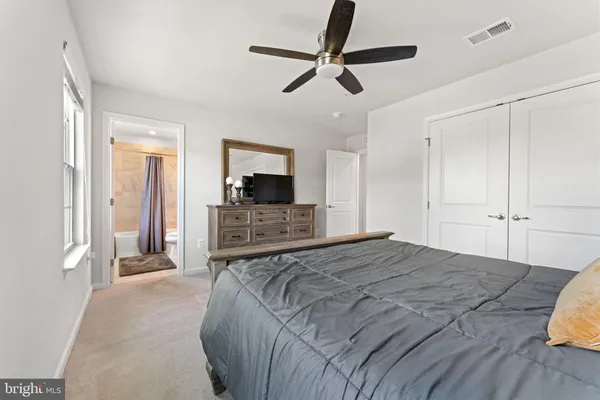 a bedroom with a large bed and a dresser