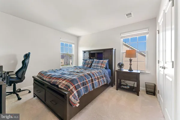 a living room with lots of furniture and a large window