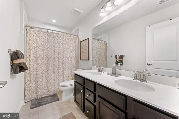a living room with lots of furniture and a chandelier