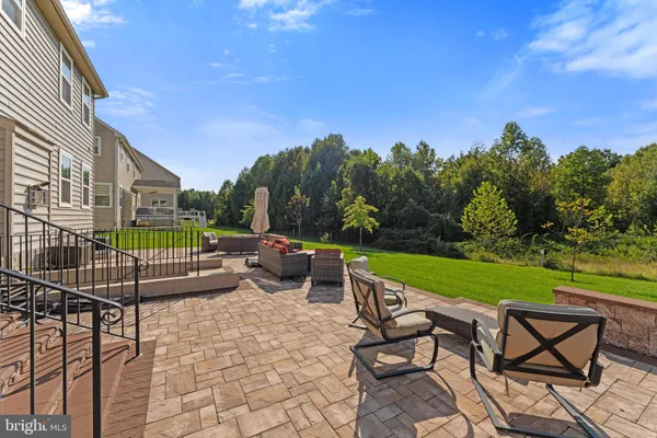 a front view of house with garden and trees